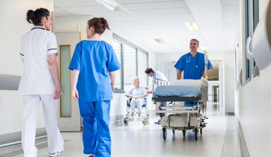 Klinikpersonal auf dem Gang in einem Klinikgebäude